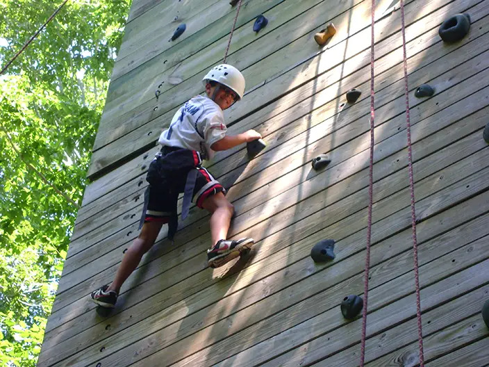 child climbing rock wall