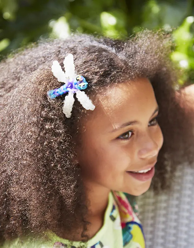 girl wearing rainbow loom dragonfly hair accessory