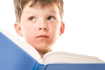 dyslexic child; boy reading a book