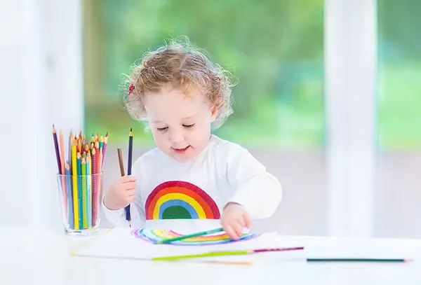 child painting rainbow