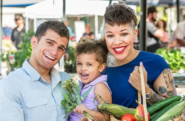family browsing farmers market
