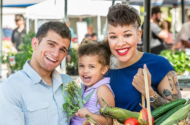 family browsing farmers market