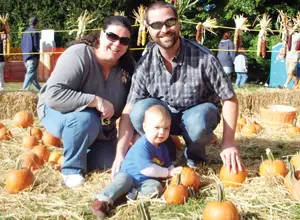 family in pumpkin patch; picking pumpkins; mill neck fall harvest festival