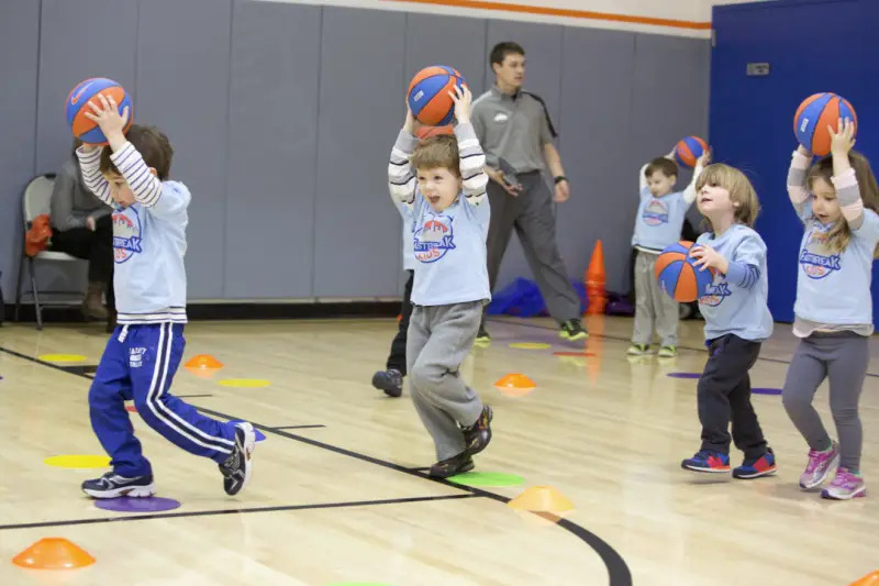 preschoolers playing basketball