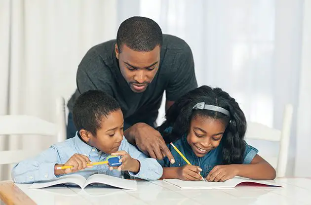 father and children doing homework