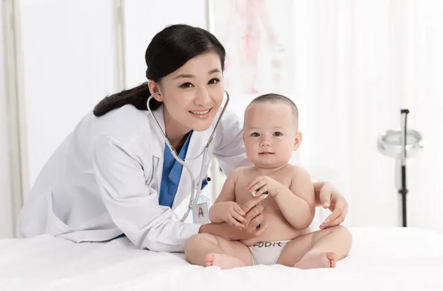 female pediatrician with baby