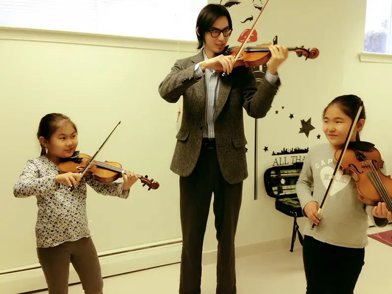 violin students with instructor