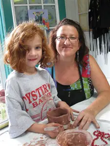 The Garden Art Studio in Mineola, NY; little girl doing arts and crafts; clay making class