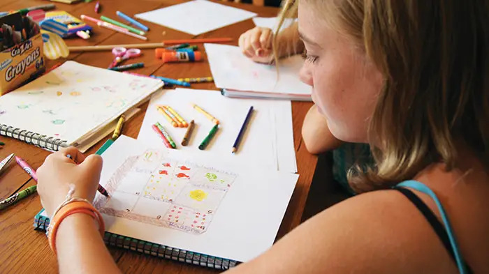 girl drawing garden map