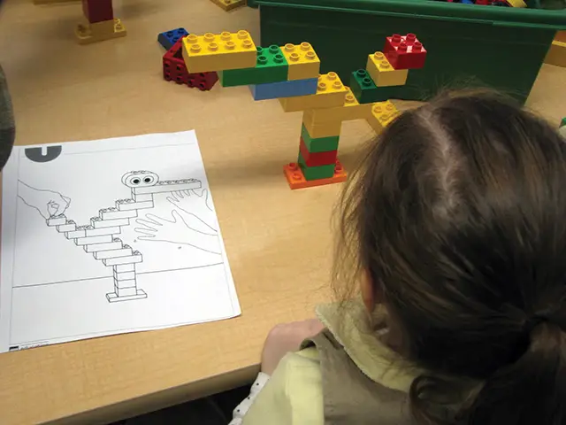 girl building with legos