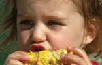 Girl eating corn