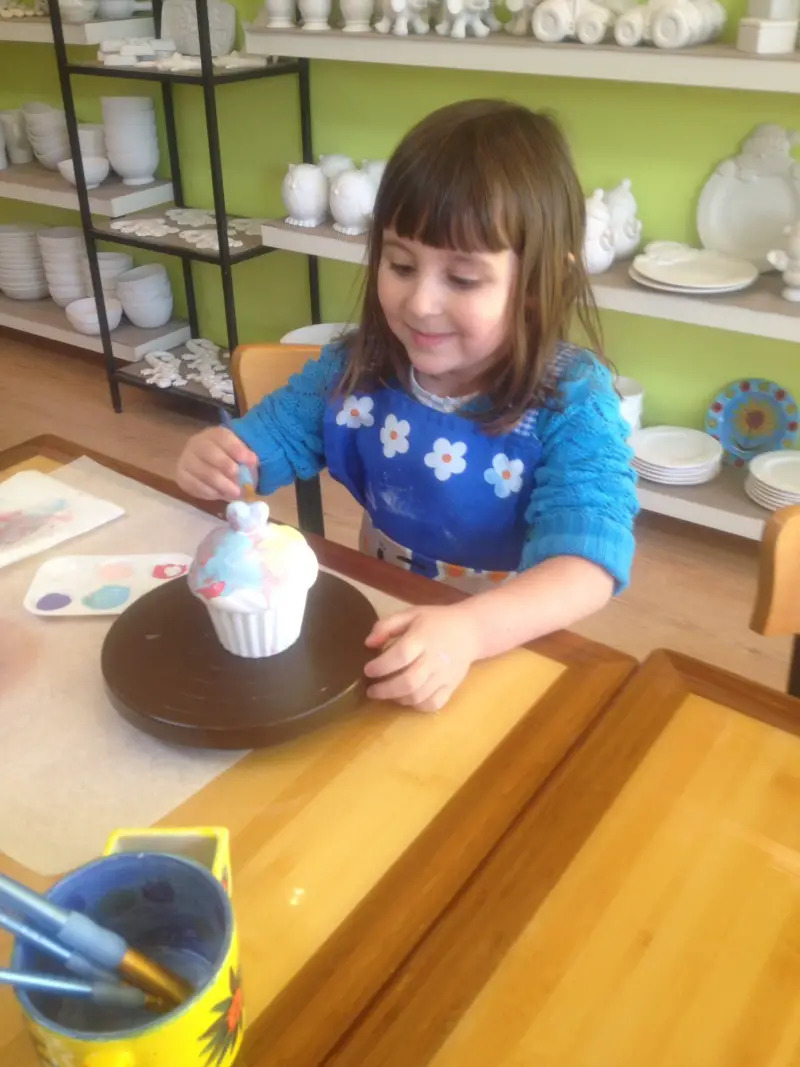 girl painting pottery