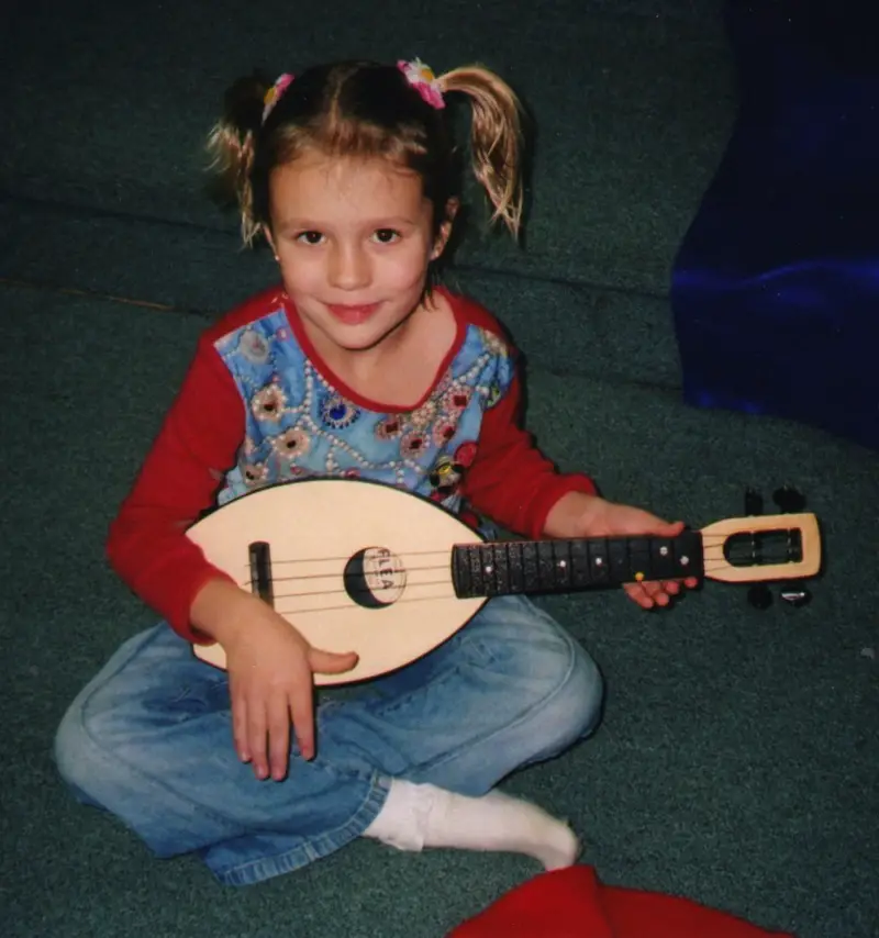 young girl playing ukulele