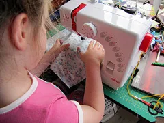 girl using sewing machine