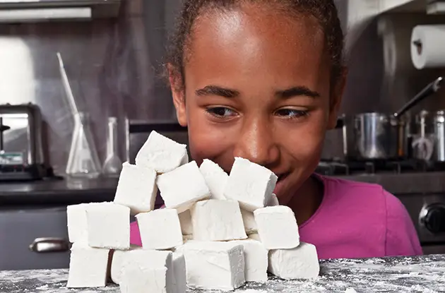 girl looking at marshmallows