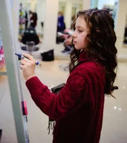 Girl writing on whiteboard