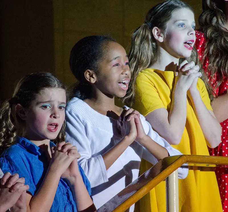 girls singing on stage