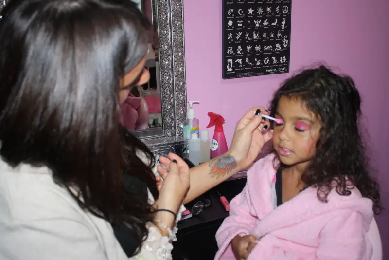 girl getting makeup applied