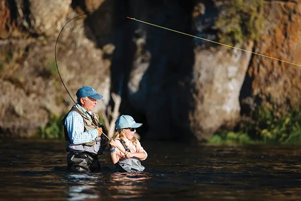 grandfather and granddaughter fly fishing