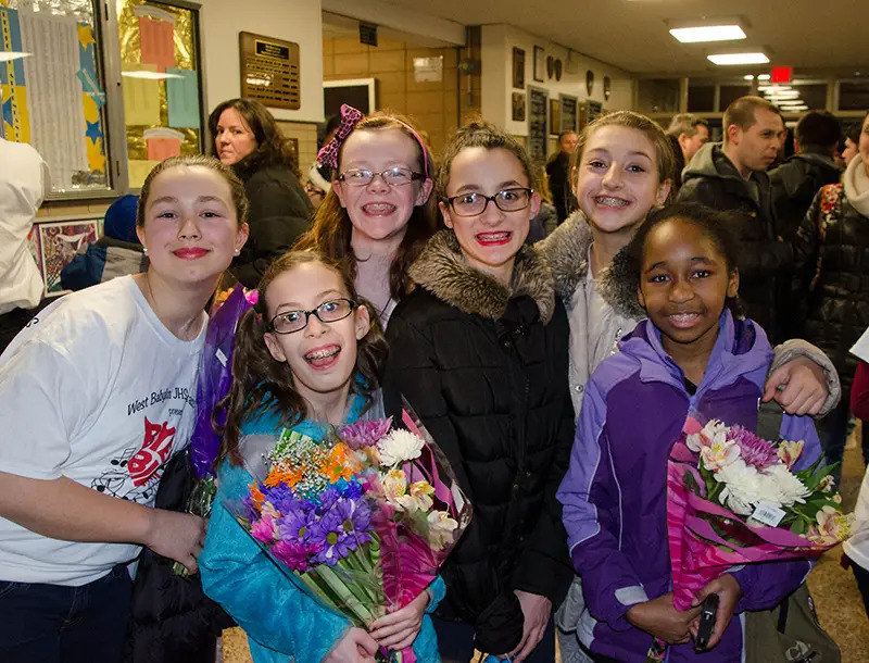 girls posing with flower backstage