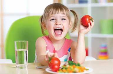 happy-girl-holding-tomato