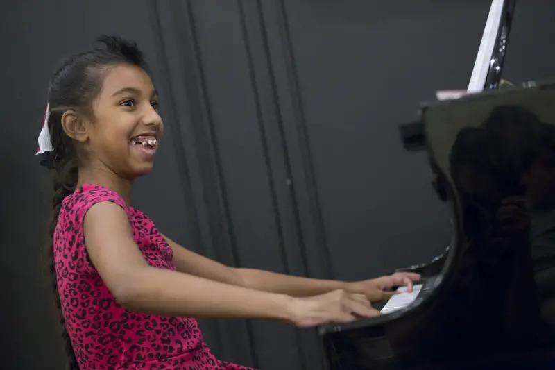 girl playing piano