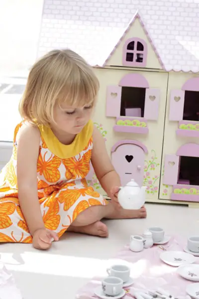 little girl playing tea party