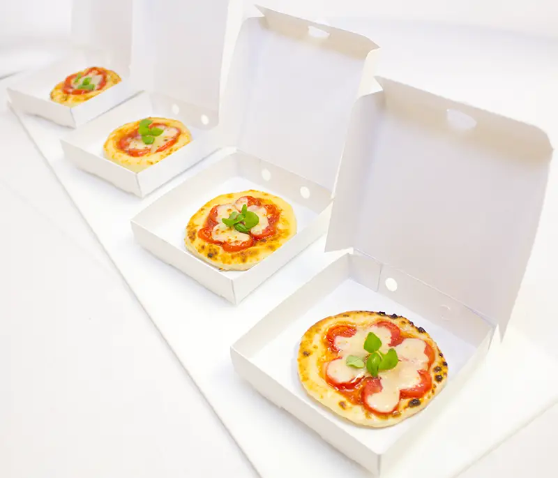 mini individual pizzas in boxes
