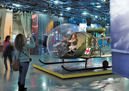 Child sitting in makeshift helicopter at the Intrepid Museum