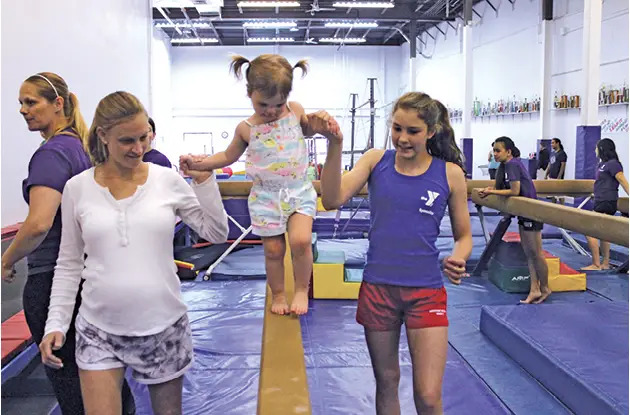 girl on balance beam at fairfield county ymca