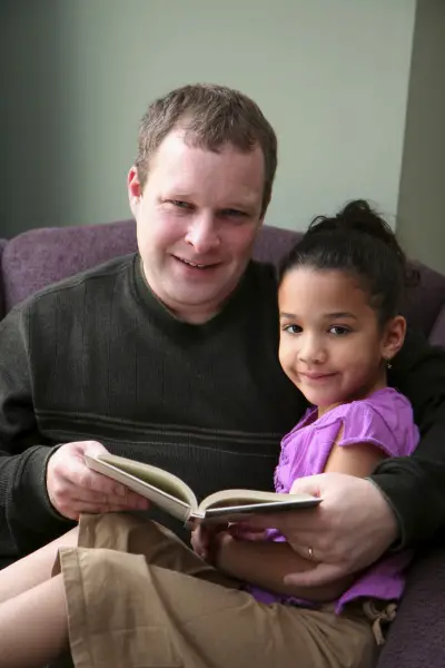 Father Reading With Daughter