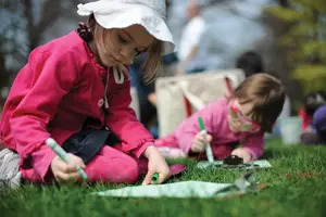 kids doing art project outside; girls coloring on the grass outside; Wave Hill