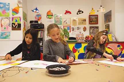 three girls drawing