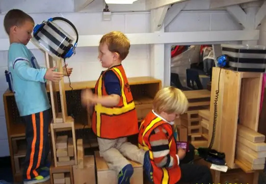 kids building airplane in classroom