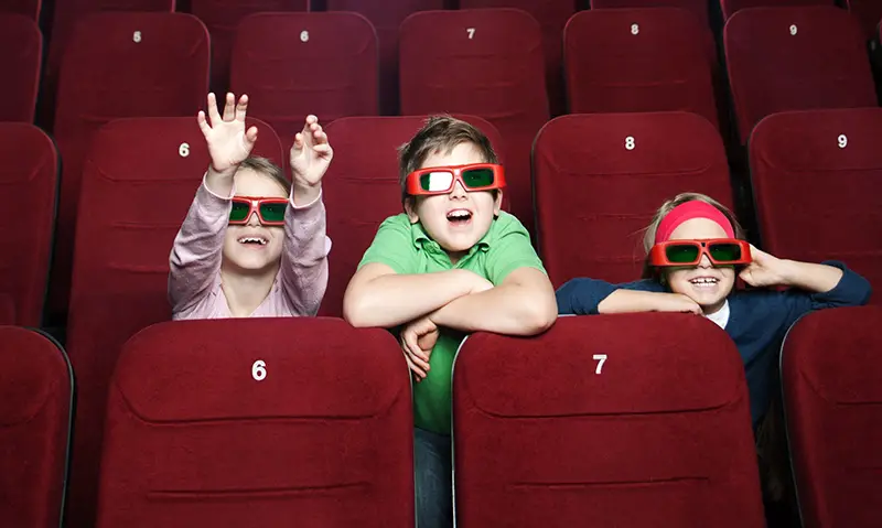 kids watching movie in theater