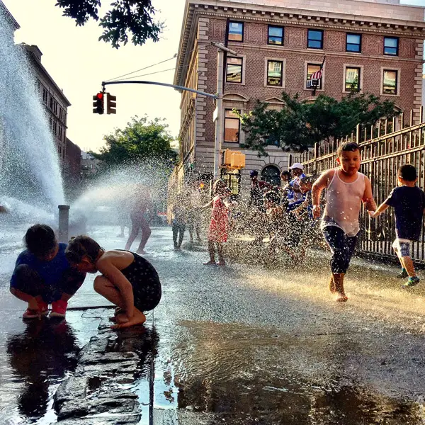 kids playing in hydrant fountain