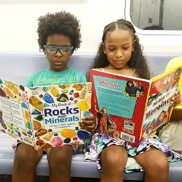 kids reading on the subway