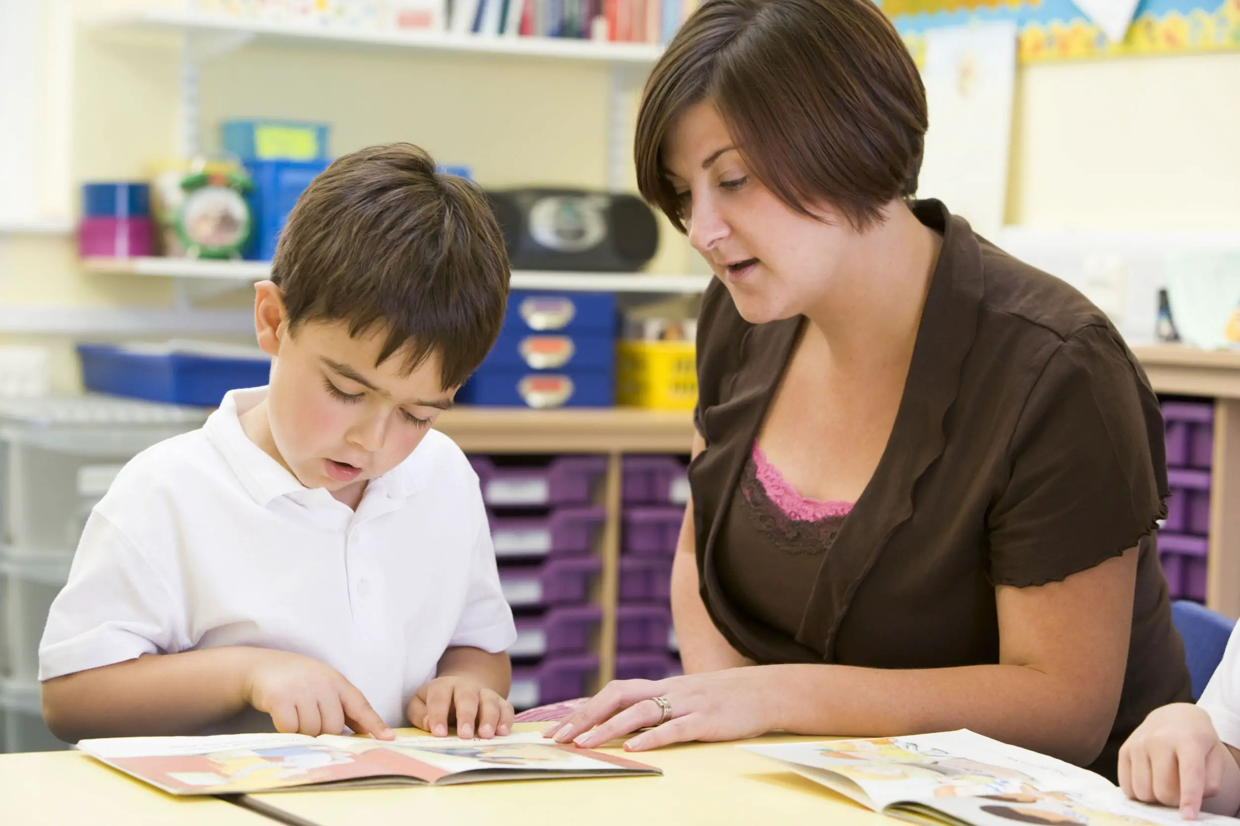 child learning to read in classroom