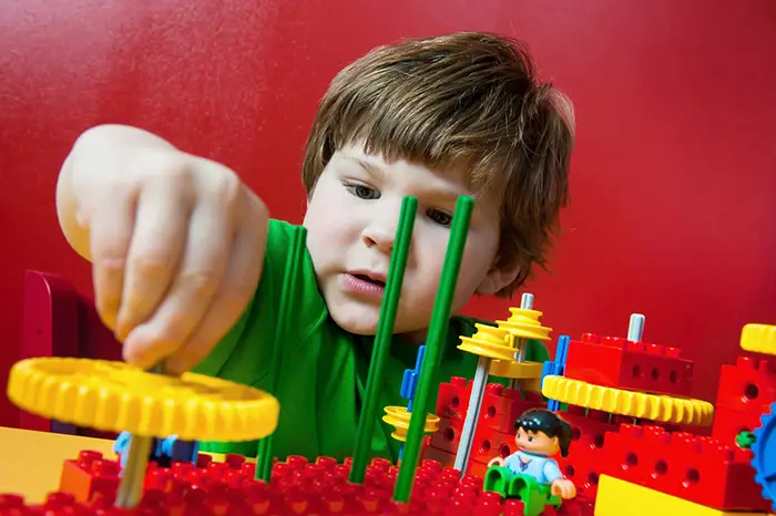 boy building with legos