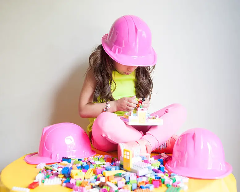 girl building with lego friends