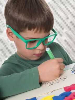little-boy-wearing-glasses-doing-homework