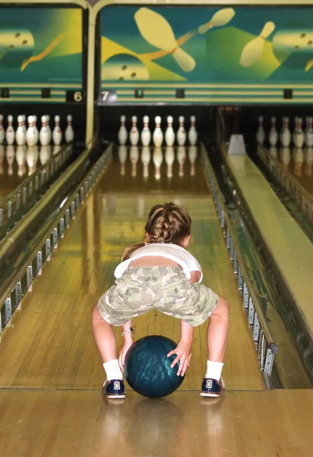 young girl bowling