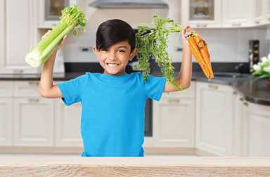 march-issue-cover-boy-with-vegetables-in-kitchen