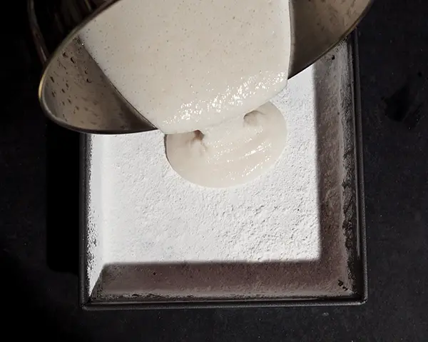 pouring marshmallow mix in pan