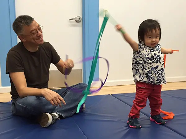 father daughter ribbon dancing