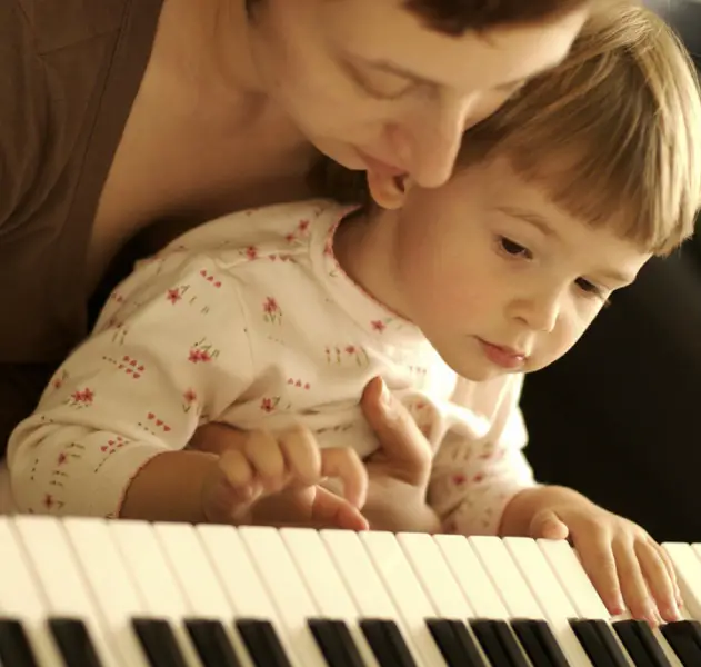 Mother and child playing piano