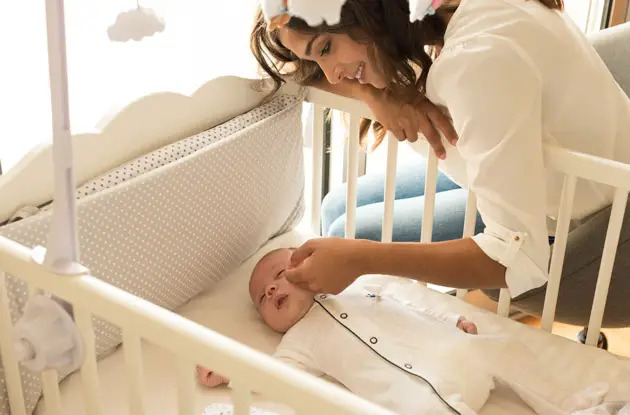 mother-checking-on-sleeping-baby