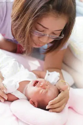 mother soothing crying baby