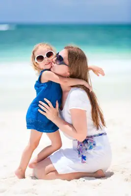 young mother and daughter at the beach