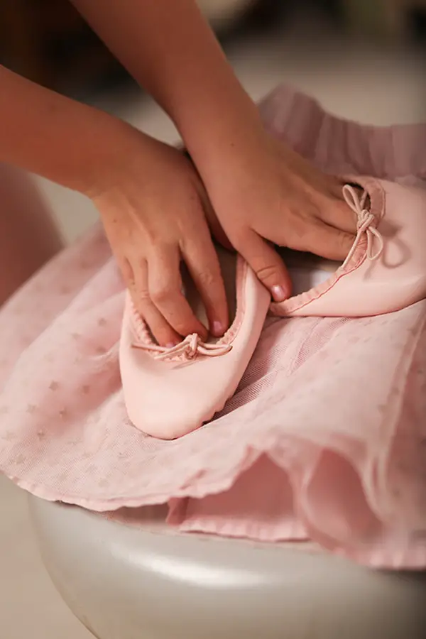 hands with ballet slippers